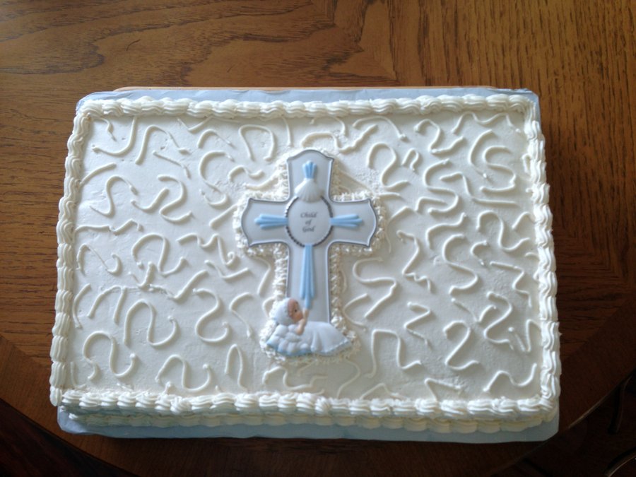 White baptism sheet cake with swirl piping and a blue cross
